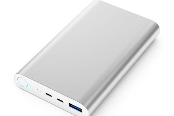 Portable external rechargeable mobile device battery charger. Gray metallic USB power bank for smartphones and tablet computers charging isolated on white background. 3D illustration